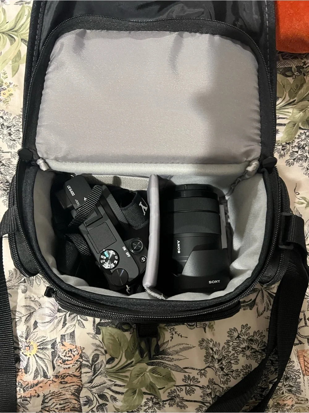 Sony Black Alpha Mirrorless A6100 Camera Body with Black Strap and Orange Accent